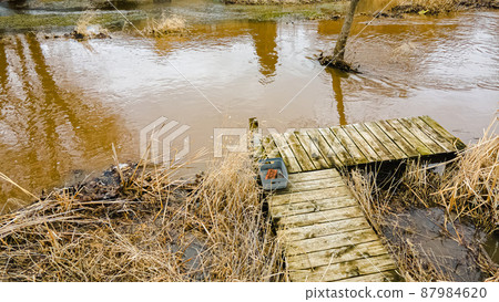 Small pier showing flooding after rain melted the snow Small pier showing flooding after rain melted the snow 87984620