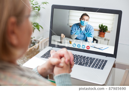 Young GP physician and elderly female patient consulting over video call Young GP physician and elderly female patient consulting over video call 87985690