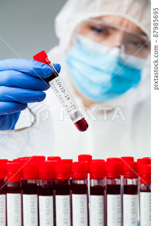 Lab technician or medical scientist wearing protective suit 87985695