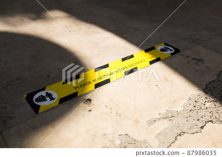 MAINTAIN A SAFE DISTANCE sign on the ground MAINTAIN A SAFE DISTANCE sign on the ground 87986035