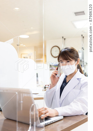 A woman working in a dispensing pharmacy A woman working in a dispensing pharmacy 87986320