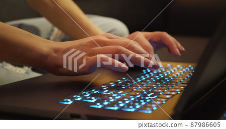 Hands typing on Keyboard Late Night Working. 87986605