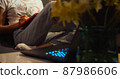 Young woman writing notes with laptop home. 87986606