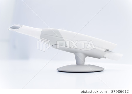 Dental intraoral scanner isolated on table in bright dentist office. Dentistry and health care concept. Close up. 87986612