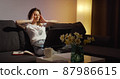 Young woman working on laptop alone in dark living late at night 87986615