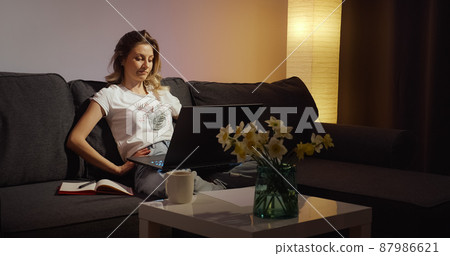 View of tired freelancer that finishes her online work on laptop. 87986621