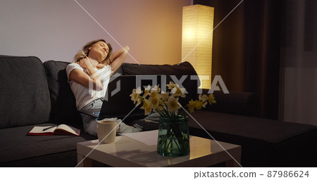 View of tired freelancer that finishes her online work on laptop. 87986624