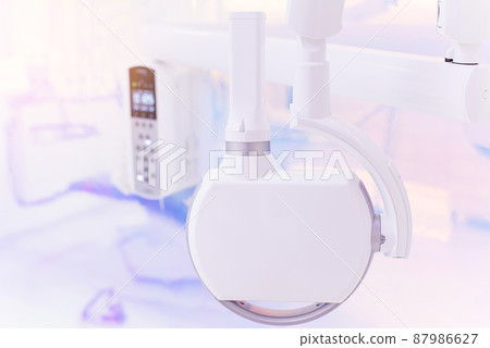 Portable intraoral x-ray machine at modern dental clinic. Healthcare and dental treatment concept. Portable intraoral x-ray machine at modern dental clinic. Healthcare and dental treatment concept. 87986627