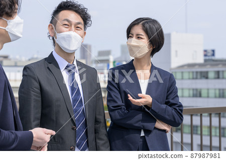 A businessman who talks while wearing a mask A businessman who talks while wearing a mask 87987981