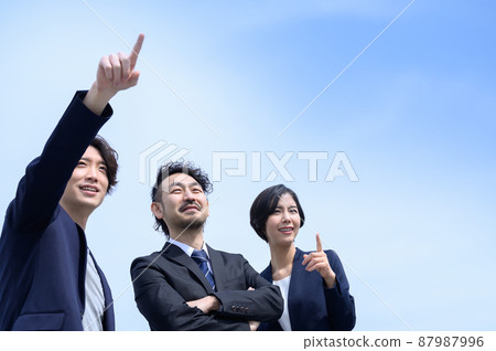 Also for the main visual! A businessman looking up at the future and goals Blue sky background Also for the main visual! A businessman looking up at the future and goals Blue sky background 87987996