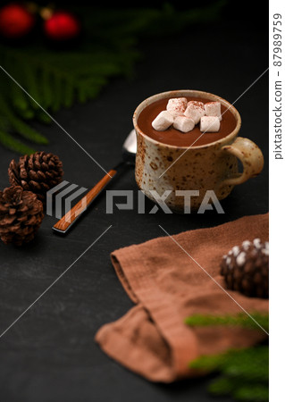 Hot dark chocolate milk with marshmallow on black table 87989759