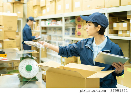 A woman working in a warehouse A woman working in a warehouse 87991851