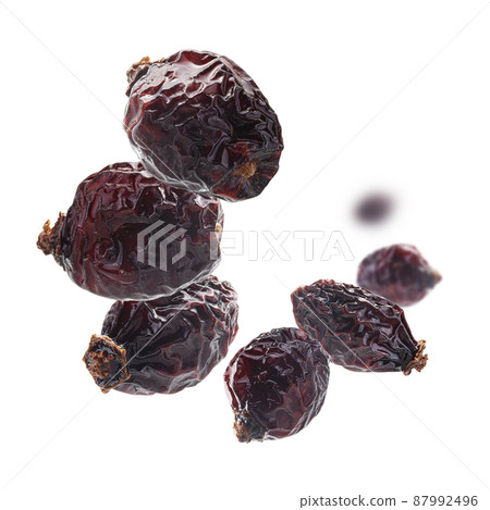 Dried rosehip berries levitate on a white background 87992496