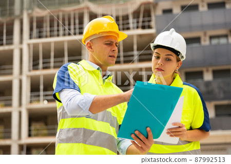 Civil engineers checking work process in construction site Civil engineers checking work process in construction site 87992513