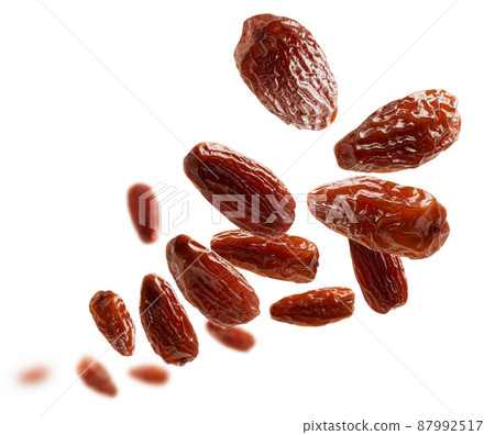 Dried dates levitate on a white background Dried dates levitate on a white background 87992517
