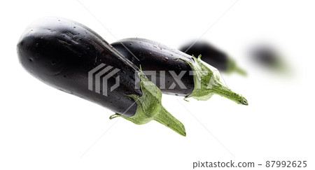 Ripe eggplants levitate on a white background 87992625