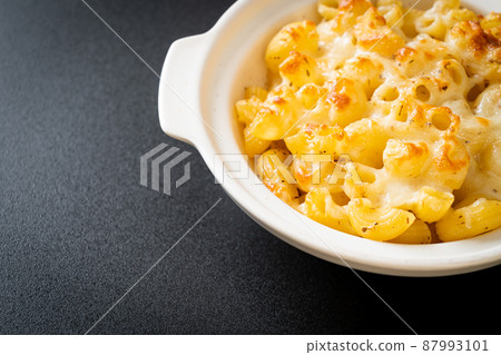American mac and cheese, macaroni pasta in cheesy sauce American mac and cheese, macaroni pasta in cheesy sauce 87993101