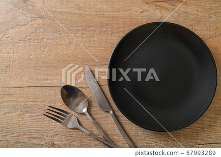 empty plate or dish with knife, fork and spoon 87993289