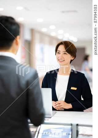 Woman at reception 87994383