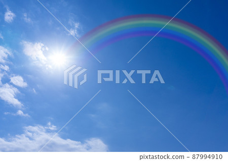 Rainbow over blue sky and white clouds_49 87994910