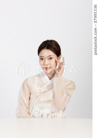 Asian Korean young woman wearing Hanbok Korean traditional clothes, beauty concept in studio Asian Korean young woman wearing Hanbok Korean traditional clothes, beauty concept in studio 87995336