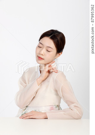 Asian Korean young woman wearing Hanbok Korean traditional clothes, beauty concept in studio Asian Korean young woman wearing Hanbok Korean traditional clothes, beauty concept in studio 87995362