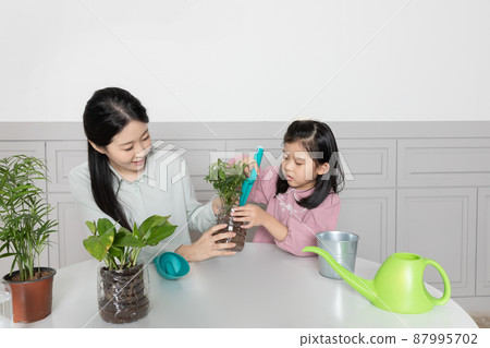 Asian Korean mom and daughter using recycled pots 87995702