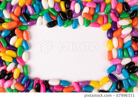 Overhead view of copy space amidst multi colored candies over white background 87996331