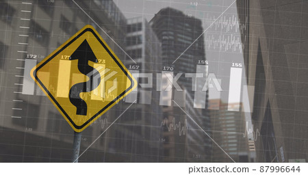 Image of financial data processing over road sign and cityscape 87996644