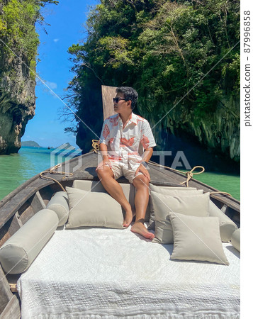 man tourist in private longtail boat trip to Lagoon koh hong near Hong island, Krabi, Thailand. landmark, destination, Asia Travel, vacation, wanderlust and holiday concept man tourist in private longtail boat trip to Lagoon koh hong near Hong island, Krabi, Thailand. landmark, destination, Asia Travel, vacation, wanderlust and holiday concept 87996858