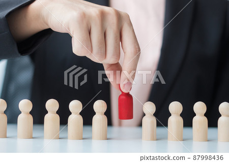 Businesswoman hand pulling leader man wooden from crowd of employees. Toxic People, Human resource management, Recruitment, Teamwork and leadership Concepts 87998436