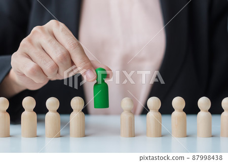 Businesswoman hand pulling leader man wooden from crowd of employees. Toxic People, Human resource management, Recruitment, Teamwork and leadership Concepts Businesswoman hand pulling leader man wooden from crowd of employees. Toxic People, Human resource management, Recruitment, Teamwork and leadership Concepts 87998438