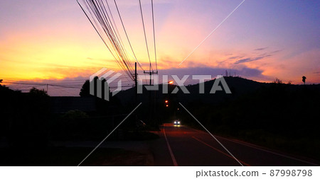 Country road with silhouette of mountain and twilight sky background 87998798
