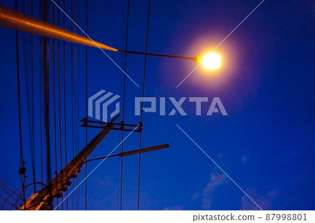 Light from street light and silhouette of electric pole with night sky background Light from street light and silhouette of electric pole with night sky background 87998801