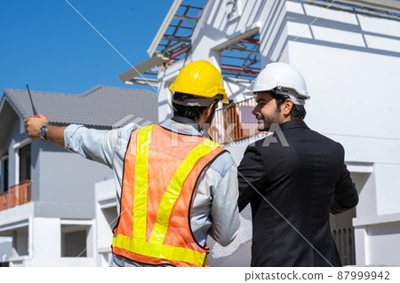 Architect and foreman meeting at construction site,Architect inspects the construction site. Architect and foreman meeting at construction site,Architect inspects the construction site. 87999942