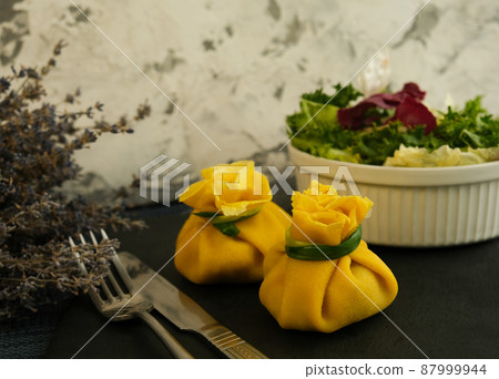 Pancakes. Yellow stuffed bliny with mushrooms and sour cream. Light background. Beautiful and delicious breakfast at home or in a cafe. Selective focus. Concept: Shrovetide menu. Slavic maslenitsu 87999944