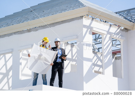 Structural engineer and foreman worker with blueprint discuss plan working for the new house Structural engineer and foreman worker with blueprint discuss plan working for the new house 88000028