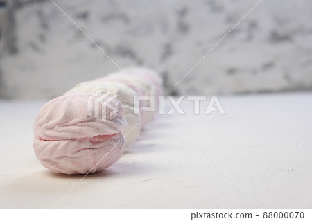 Marshmallow without packaging close-up on a white background. side view. Zephyr pink and white. Protein sweetness. Air dessert. 88000070