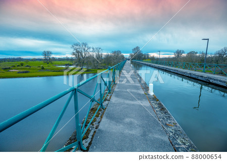 Boat canal bridge over Laura river in early spring at sunset. Digoin, France. Boat canal bridge over Laura river in early spring at sunset. Digoin, France. 88000654
