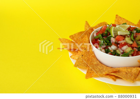 Pico de Gallo and chips on yellow background Pico de Gallo and chips on yellow background 88000931