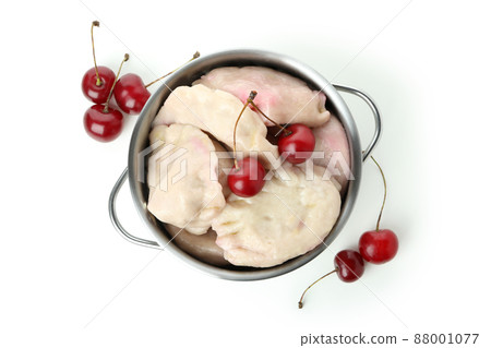 Pot with pierogi with cherry isolated on white background Pot with pierogi with cherry isolated on white background 88001077