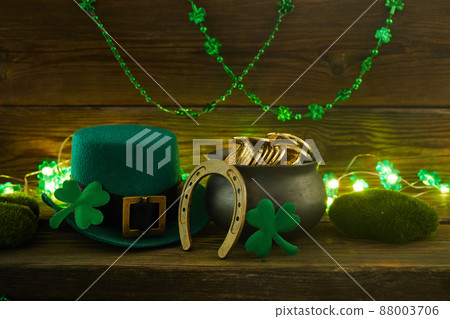 Happy St Patricks Day leprechaunt with gold coins on vintage style green wood background Happy St Patricks Day leprechaunt with gold coins on vintage style green wood background 88003706