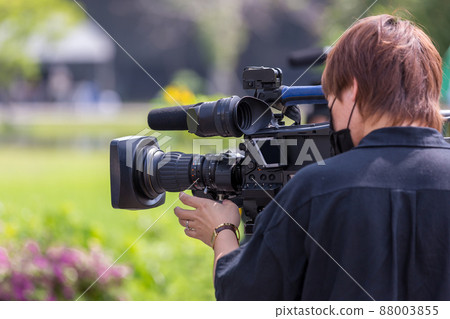 Video camera operator working with his equipment.  88003855