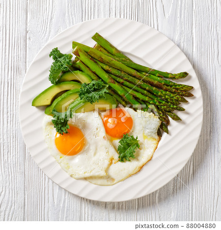 roast asparagus, ripe avocado and fried eggs roast asparagus, ripe avocado and fried eggs 88004880