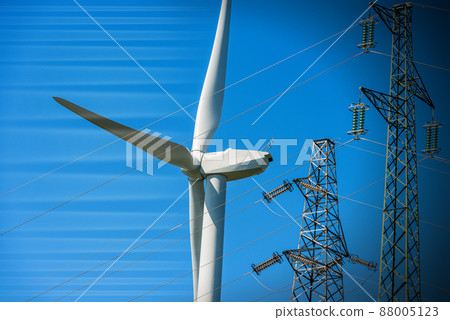 Wind Turbine and High Voltage Towers against a Clear Sky - Renewable Energy 88005123