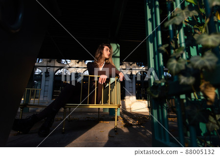 Portrait of a fashionable young brunette woman with long legs wearing solid long sleeve bodycon one piece jumpsuits Portrait of a fashionable young brunette woman with long legs wearing solid long sleeve bodycon one piece jumpsuits 88005132
