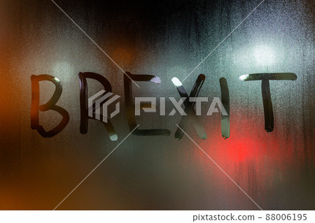 the word brexit written on night wet window glass close-up with blurred background 88006195