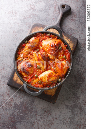 Baked chicken with sofrito vegetable sauce close-up in a frying pan. vertical 88006272