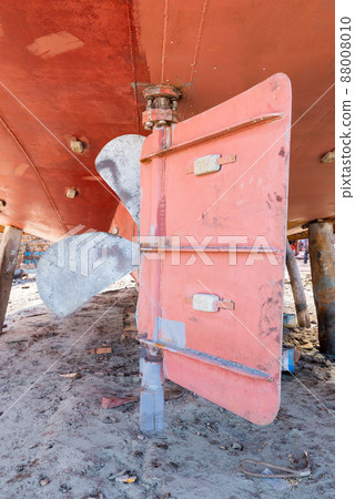 Metal propeller of ship on ground in old shipbuilding plant on coast 88008010