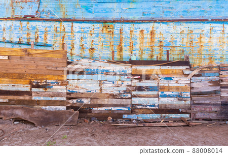 Shabby paneled wall on dirty empty beach 88008014